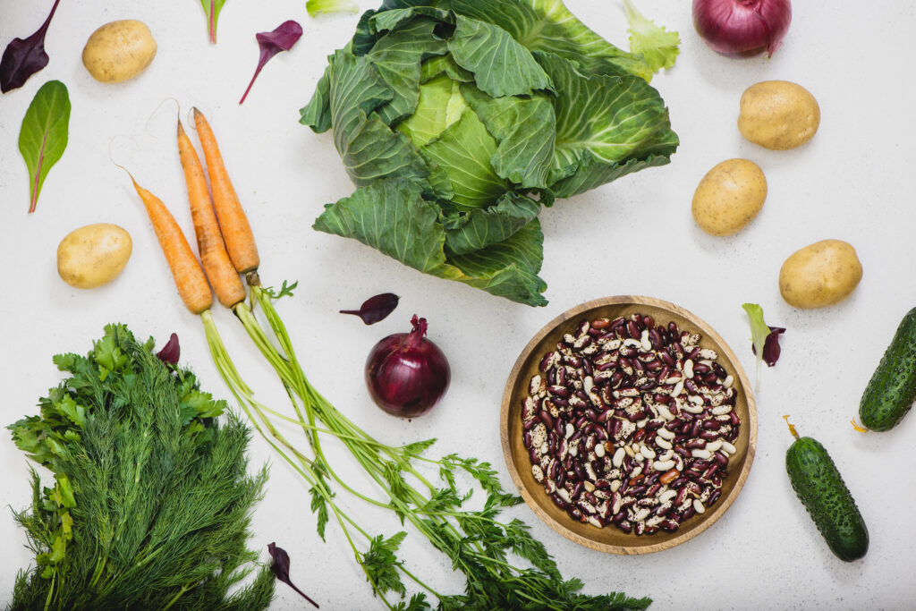 A table with fresh vegetables and beans.